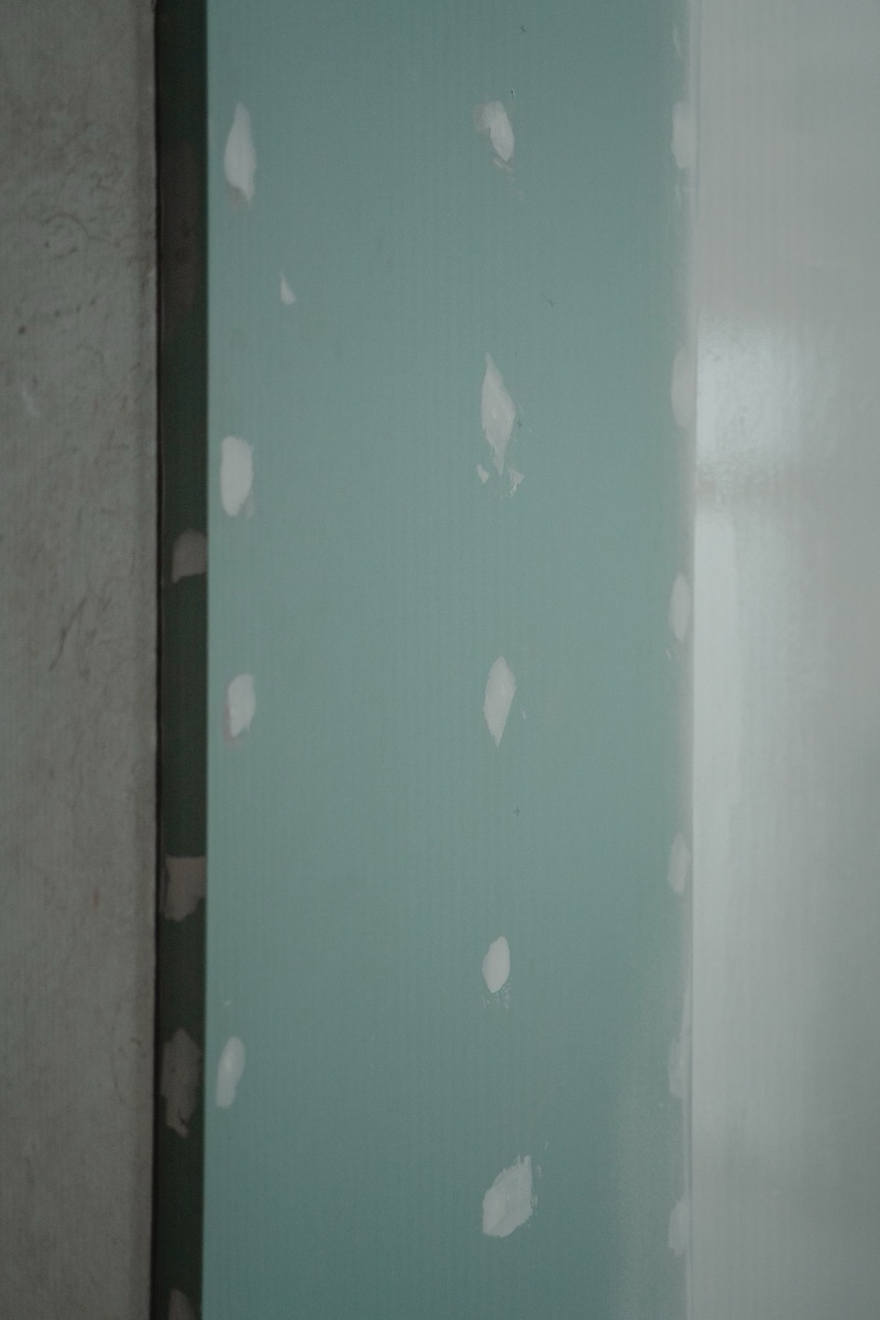 Freshly hung drywall with taped and patched seams