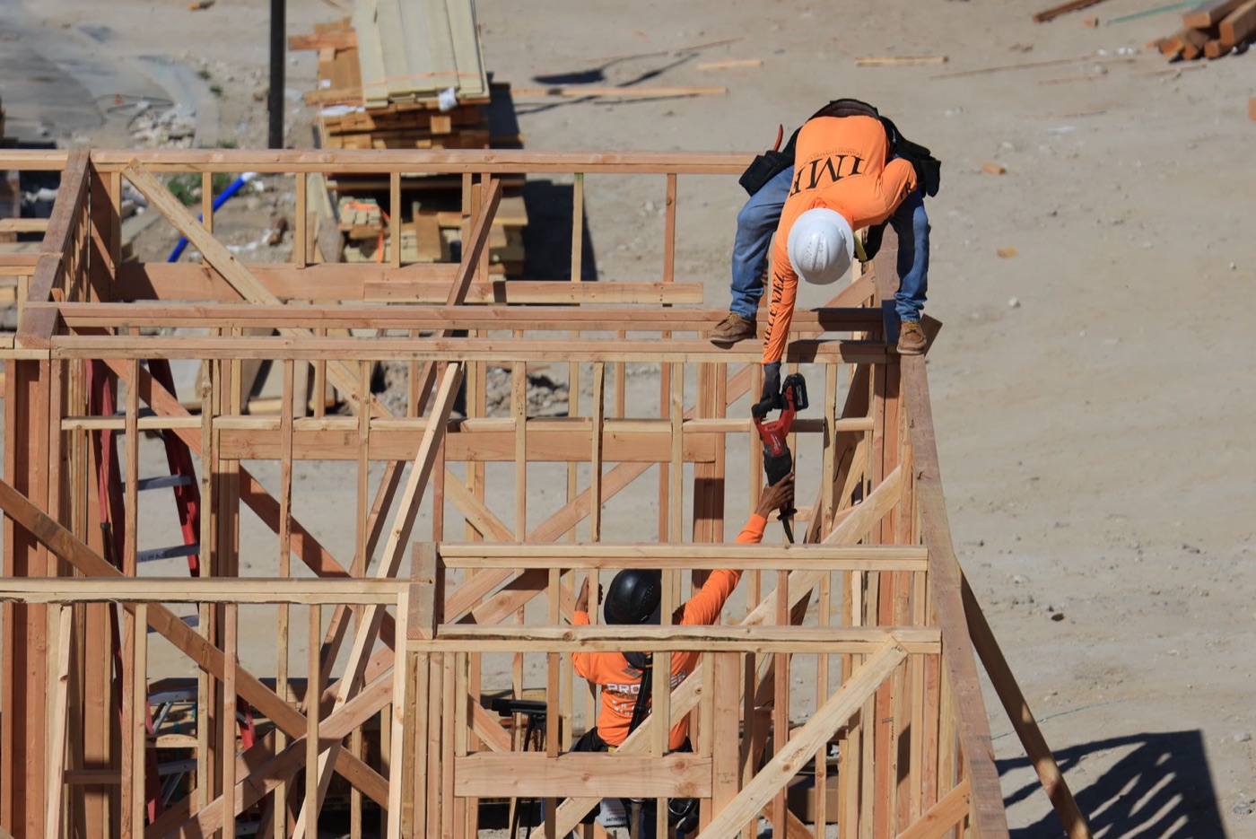Framing crew working on a wood structure at a building site